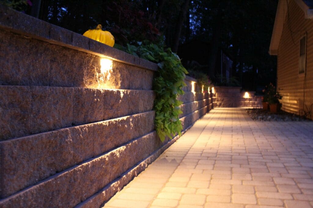 retaining wall with built in lights and paver patio