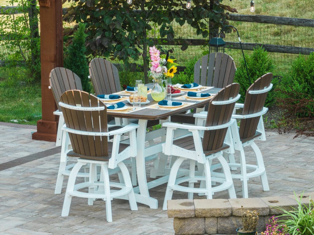 Vertical view of a stylish outdoor patio furniture set with comfortable seating and vibrant cushions, placed on a spacious patio. The elegant design of the furniture enhances the outdoor space, creating a perfect spot for relaxation and gatherings.