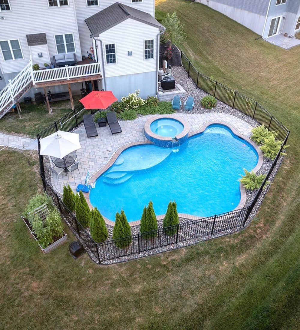 aerial view of pool behind house